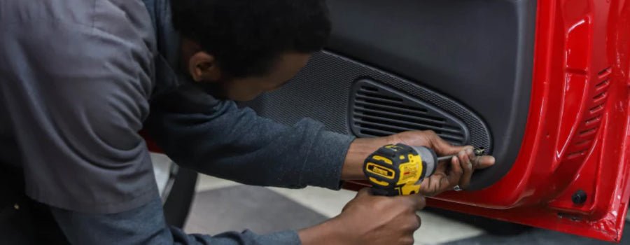 Guy installing speaker inside car door