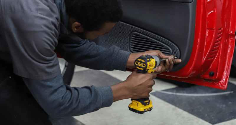 Guy installing speaker inside car door