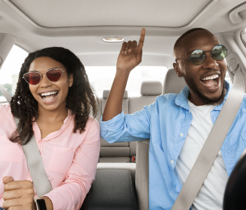 couple singing in the car smiling mobile