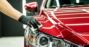 Glove hand detailing red car Mobile