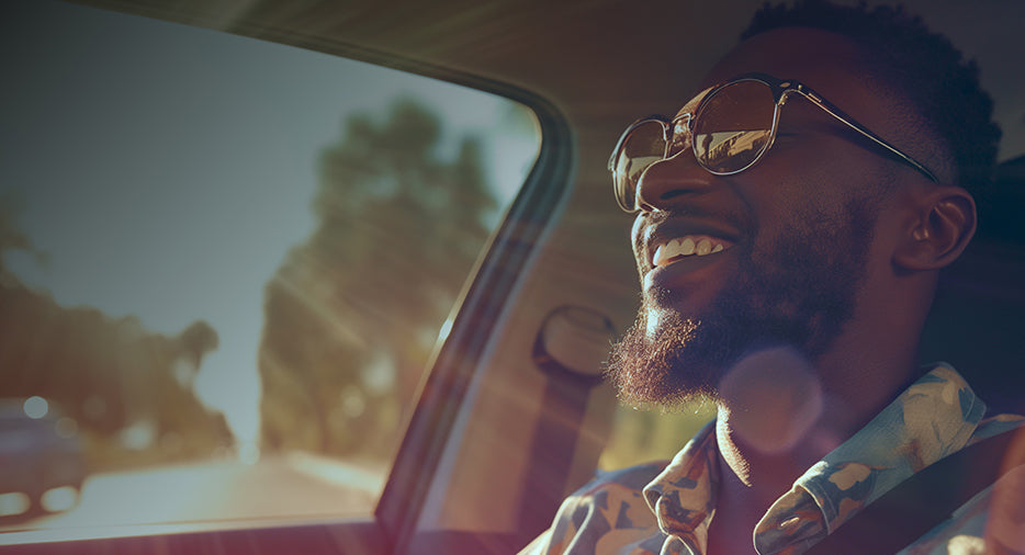 Guy with sun glasses driving in Car